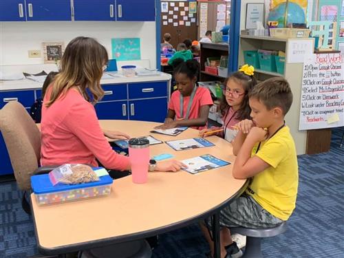 students working with a teacher